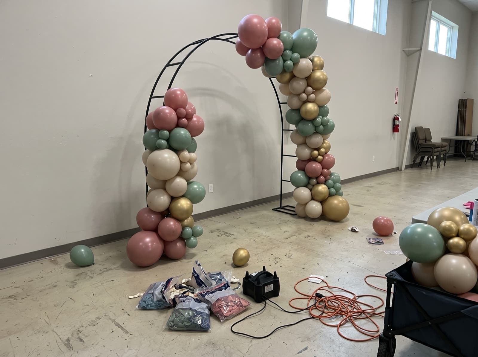 Organic balloon garland being built on an arch frame before an event