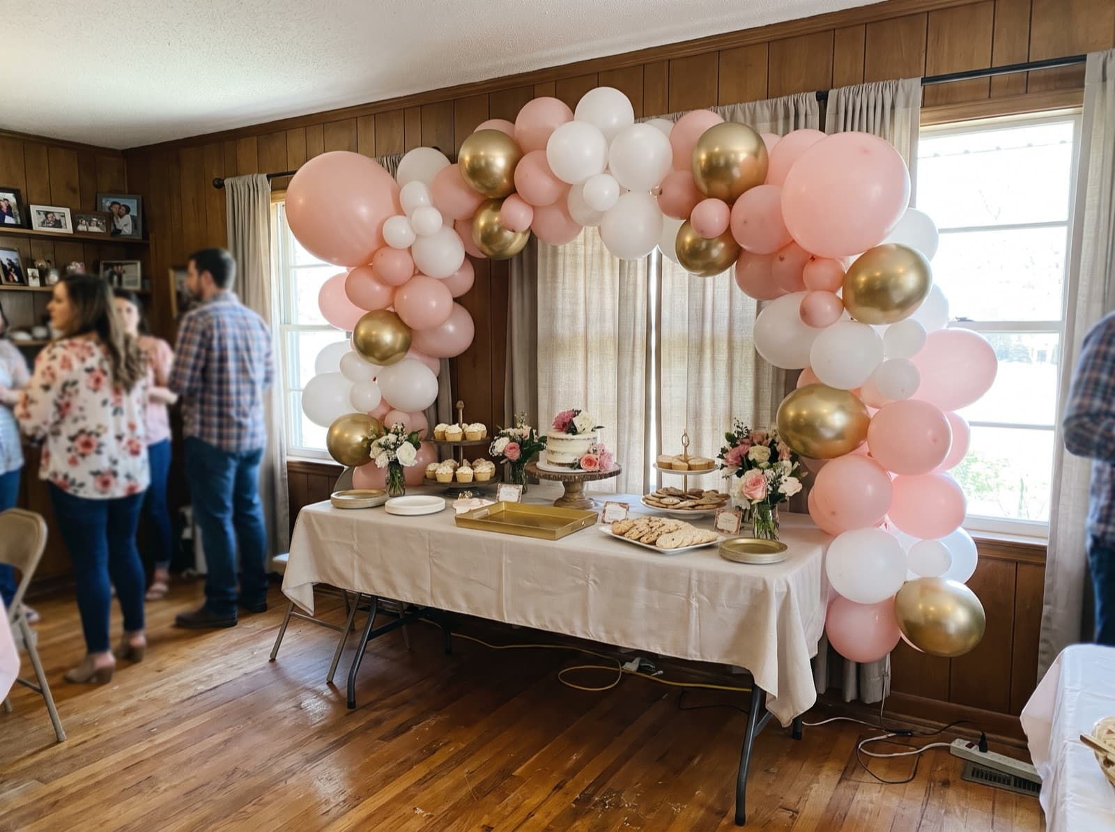 Organic balloon arch in blush, white and gold over a dessert table at a Houston birthday party