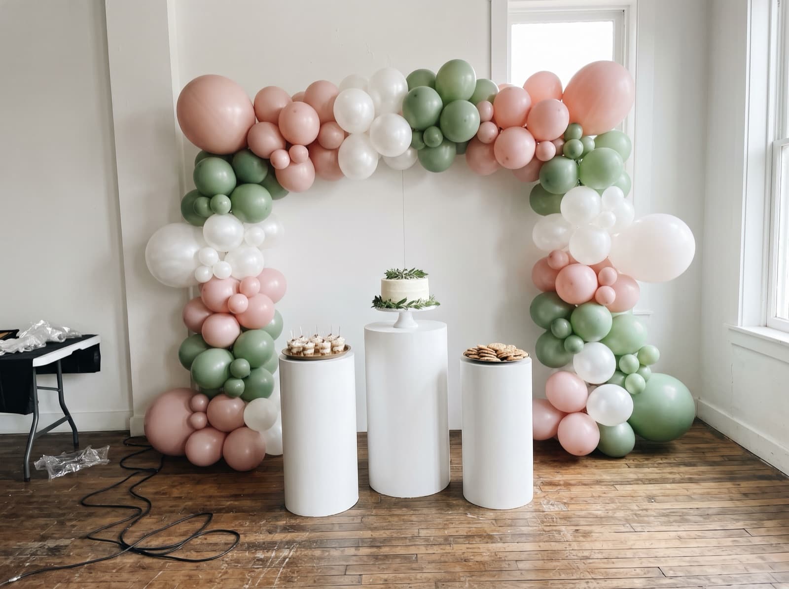 Backdrop with pedestals and a cake table