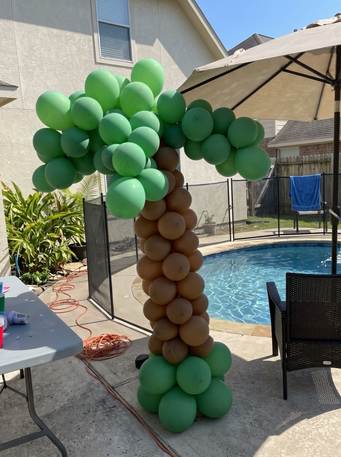 Palm tree balloon column at a pool party