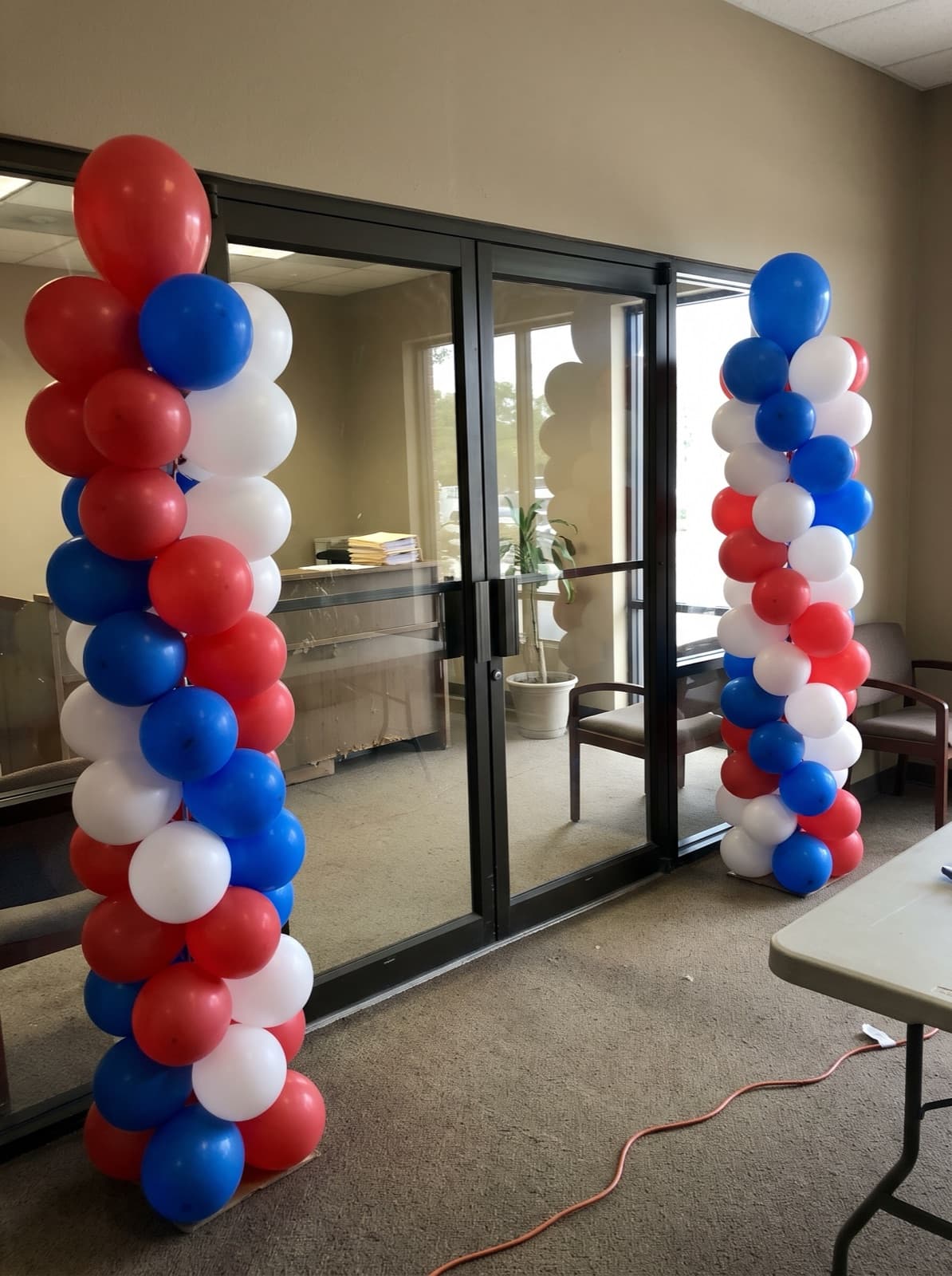Red, white and blue spiral balloon columns