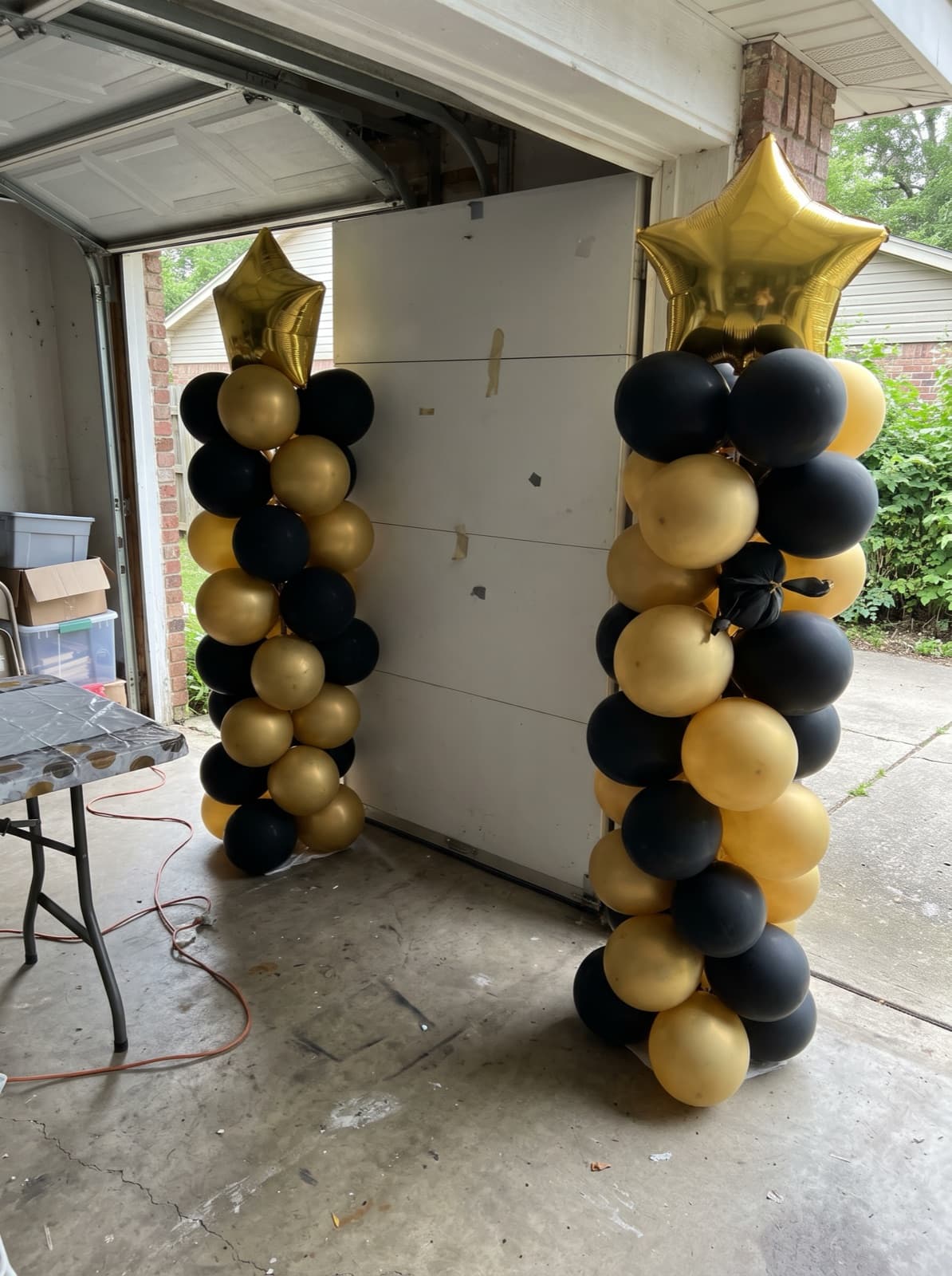Balloon columns with gold star toppers for a graduation