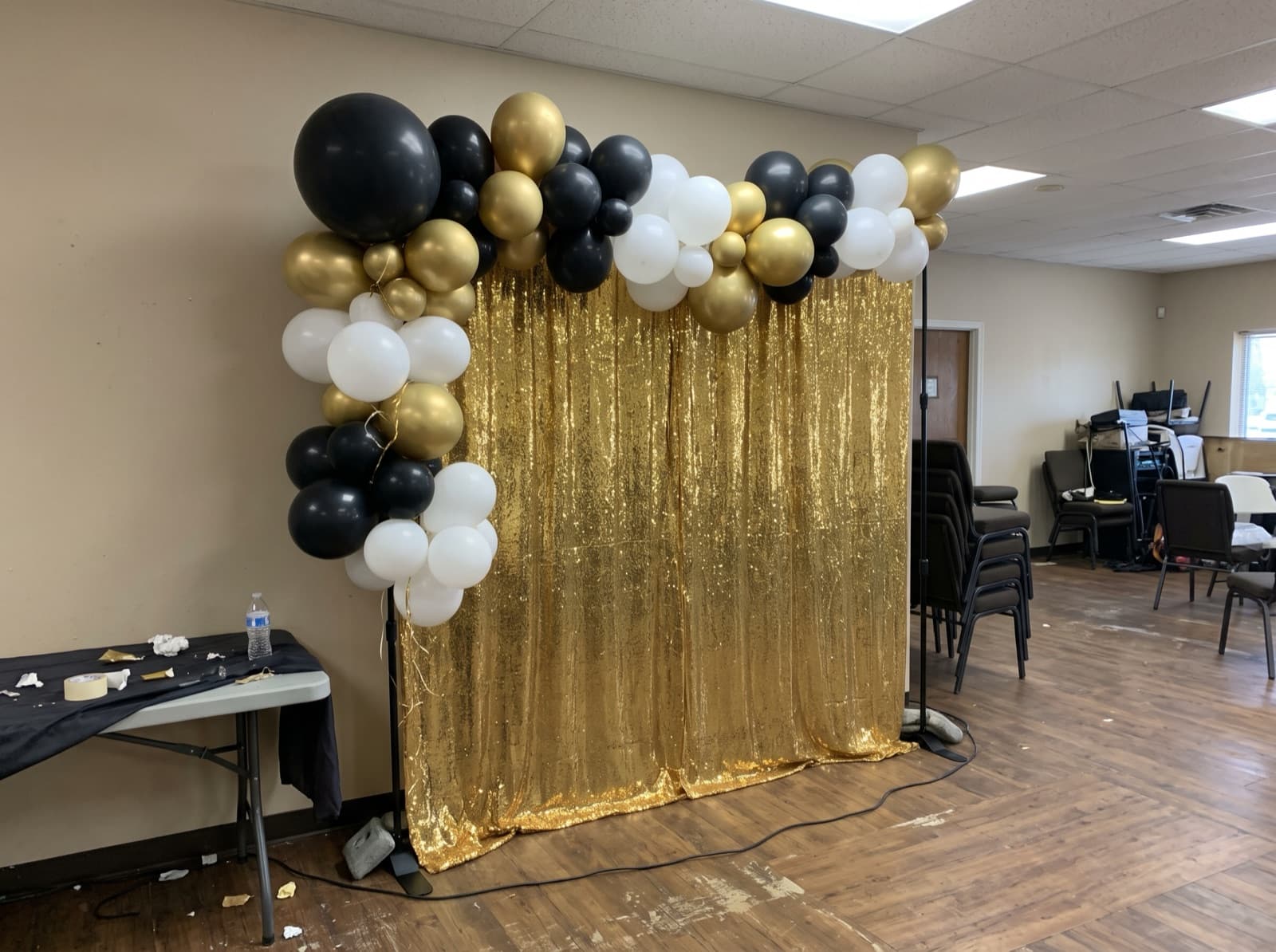 Balloon garland over a gold shimmer wall