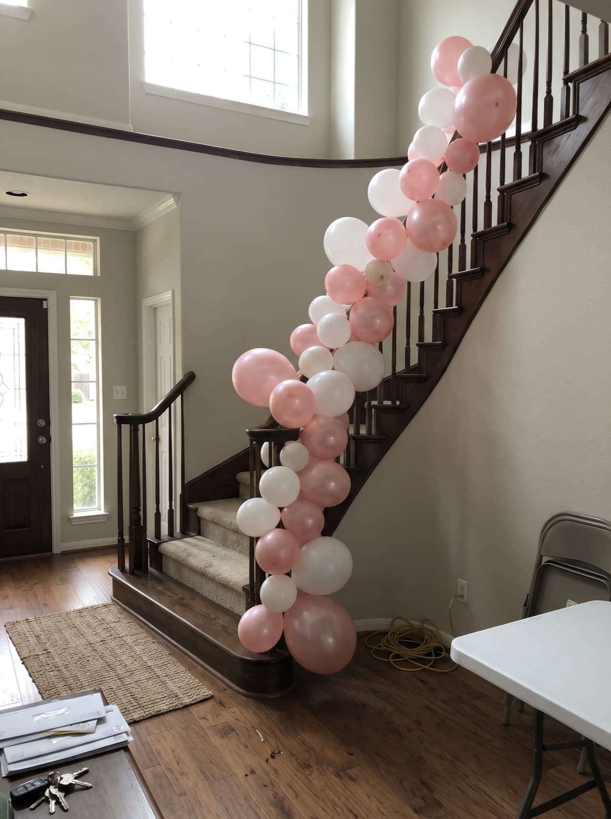 Balloon garland running down a staircase banister