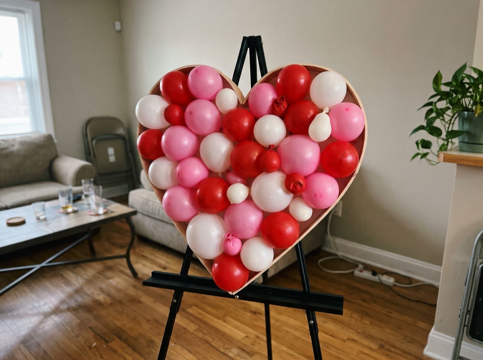 Heart-shaped balloon mosaic in red and pink