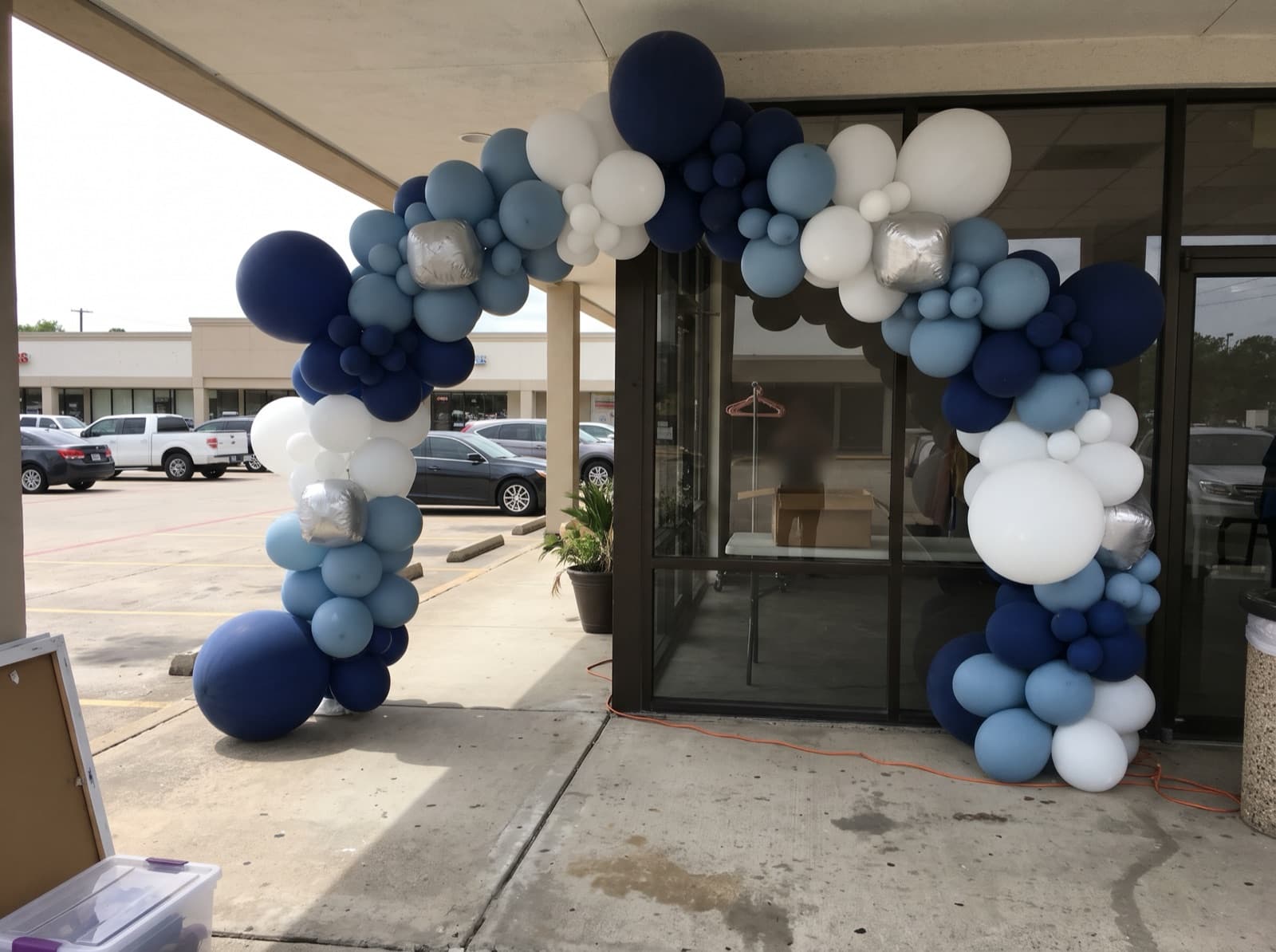 Giant balloon arch installation over a storefront