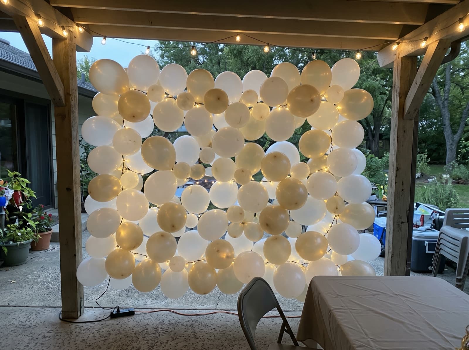 Balloon wall with string lights for an evening party